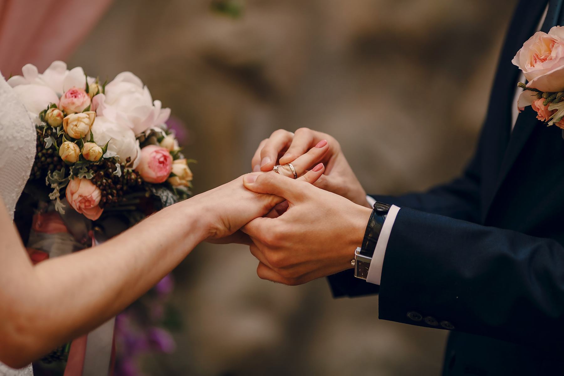 Detalhe das mãos e alianças do casal